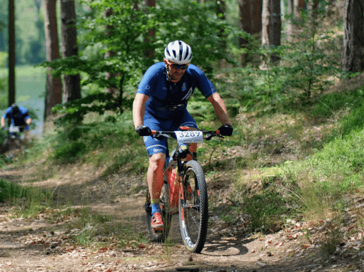 Mountain biker wearing breathable performance jersey on a technical trail