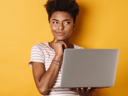 A thoughtful young woman holding a laptop, looking upward as she considers how AI can help organize her writing projects and ideas.