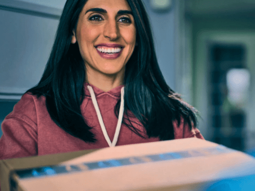 A happy shopper receiving her Amazon box at the door.