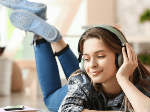 Young lady listening to audiobook with headphones