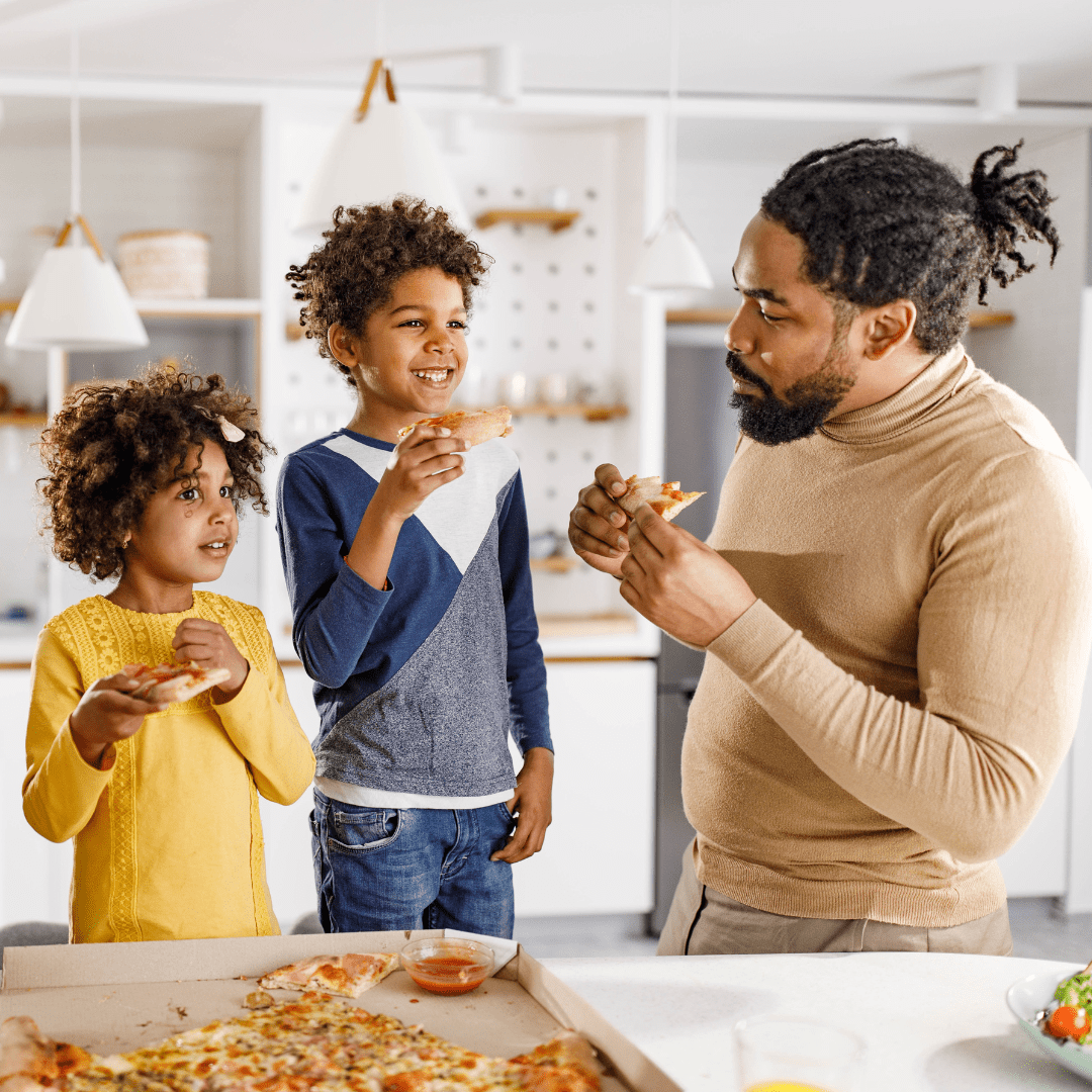 Family gathered around a table sharing takeout food and enjoying dinner together.