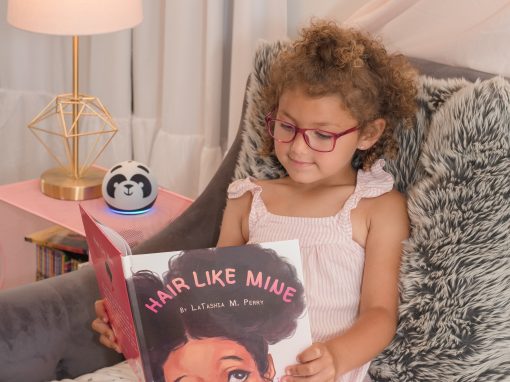 Child reading sidekick with an Amazon Echo Dot Kids speaker panda version.