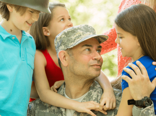 Soldier reunited with wife and children, symbolizing healing and return to family after war.