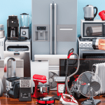 A large assortment of refurbished home appliances including a refrigerator, fan, heater, microwave, mixer, blender, vacuum cleaner, stove, and more, representing the variety available through Amazon Renewed.