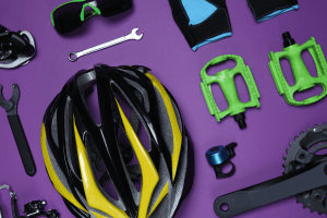 Assorted cycling gear including helmet, pump, tools, and pedals