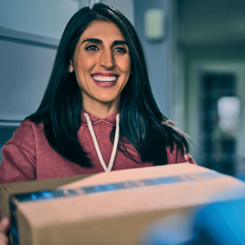 Exclusive Amazon Sale and Fast, Free Delivery A happy shopper receiving her Amazon box at the door.